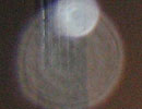 Overlapping pale circular light spots (angel orbs) against a dark indoor background