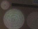 Greenish circular light spot (angel orbs) with a smaller pale spot above it