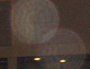 Faint circular light spot (angel orbs) overlapping a dark horizontal structure