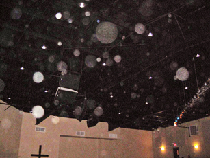 Ceiling with numerous pale circular light spots (angel orbs) in the photograph
