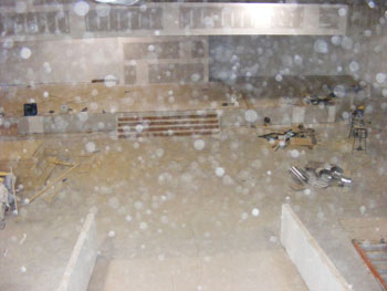 Construction floor and stacked materials obscured by dense circular light spots (angel orbs)