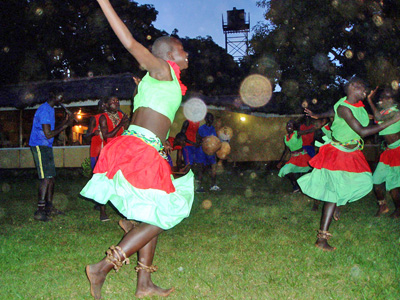 Dancers in colorful skirts outdoors with circular light spots (angel orbs) in the photograph