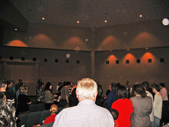 Church congregation and ceiling with pale circular light spots (angel orbs) in the photograph