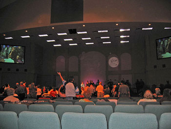 Church congregation and ceiling with pale circular light spots (angel orbs) in the photograph