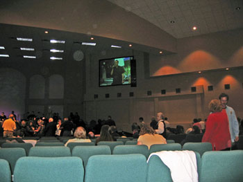 Church congregation and ceiling with pale circular light spots (angel orbs) in the photograph