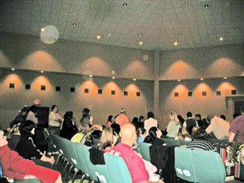 Church congregation and ceiling with pale circular light spots (angel orbs) in the photograph