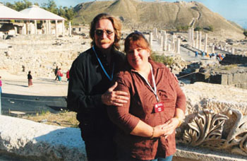 Couple visiting an archaeological site with mountains in the distance