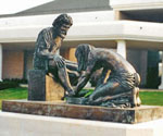 Divine Servant® sculpture outside a building with white columns