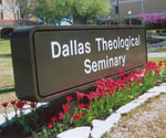 Dallas Theological Seminary entrance sign beside red flowers
