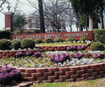 East Texas Baptist University entrance sign surrounded by flowers