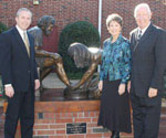 Visitors beside a Divine Servant® sculpture on a pedestal
