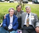Three men seated together outdoors
