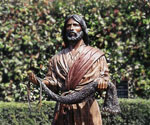 Front view of Fisher of Men® holding the net before leafy shrubs