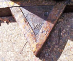 Close-up of an inscription on the sculpture's triangular base