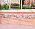 First Baptist Church lettering beneath decorative windows