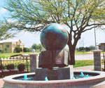 The Great Commission® globe fountain beneath a tree