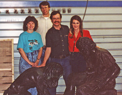 Four people behind Divine Servant® components in a workshop