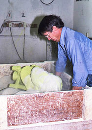 Foundry worker handling a pale mold component