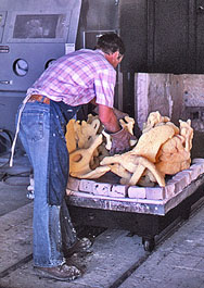 Worker arranging molds inside a kiln