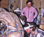 Max Greiner and a worker beside cast Divine Servant® figures