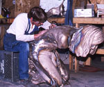 Worker finishing the kneeling Jesus figure