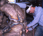 Worker refining the back of the kneeling Jesus figure