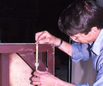 Worker using a balance scale during the casting process