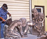 Worker finishing Divine Servant® outside a workshop
