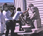 People moving a Divine Servant® sculpture outdoors