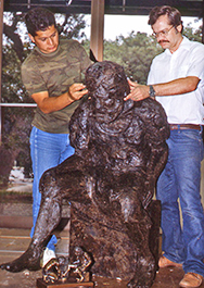 Two artists working on Peter's head in Divine Servant®