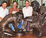 Three visitors standing behind Divine Servant®