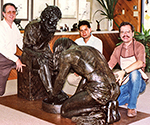 Three visitors beside Divine Servant® in the studio