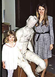 Woman and child beside a seated figure armature