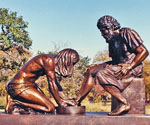 Divine Servant® bronze sculpture displayed outdoors in sunlight