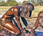Close side view of the kneeling Jesus figure and basin in Divine Servant®