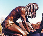 Close side view of the kneeling Jesus figure and basin in Divine Servant®