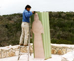 Worker trimming foam around the full-length template