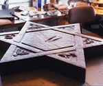 Star-shaped sculpture base with relief panels on a worktable