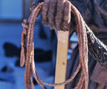 Close-up of the rope and net loop held by the figure