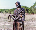 Fisher of Men® holding a fishing net in a natural landscape
