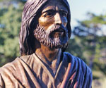 Close-up of the bronze face, beard and robe collar of Fisher of Men®