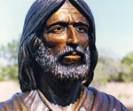 Close-up of the bronze face, beard and robe collar of Fisher of Men®