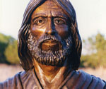 Close-up of the bronze face, beard and robe collar of Fisher of Men®