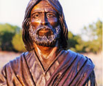 Close-up of the bronze face, beard and robe collar of Fisher of Men®