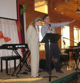 Max and Sherry Greiner speaking at a lectern