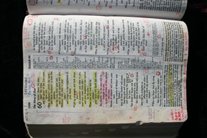 Open Bible with handwritten notes and highlighted passages in Isaiah 60