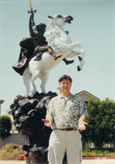 Man standing outdoors before The Coming King® sculpture