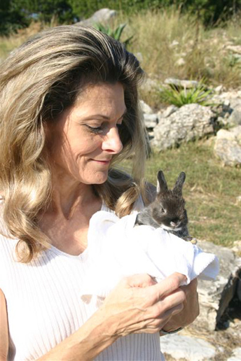 Sherry Greiner holding a white rabbit with dark ears
