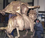 Large cast sections of the rider's cloak beside the metal horse