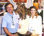 Artist and woman standing beside the mounted-rider sculpture model